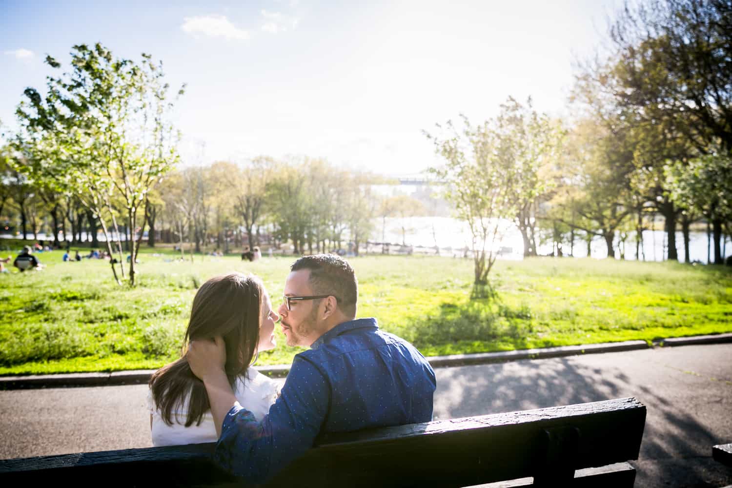 Couple kissing on bench during an Astoria Park engagement shoot
