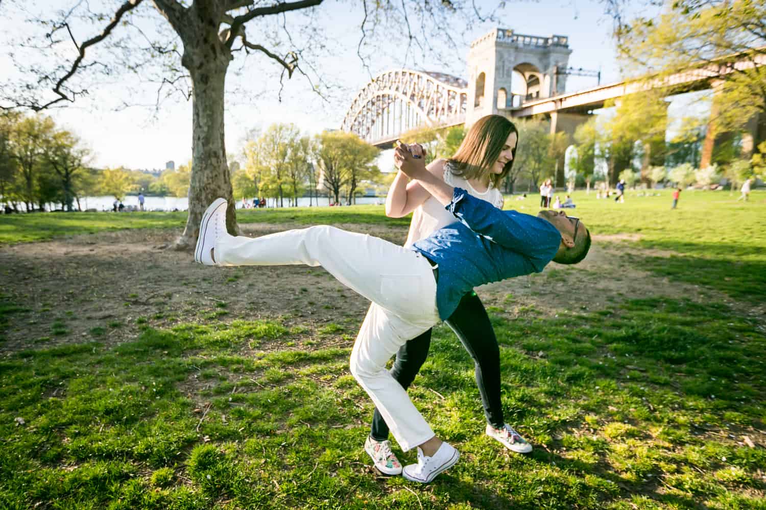Woman dipping man while dancing during an Astoria Park engagement shoot