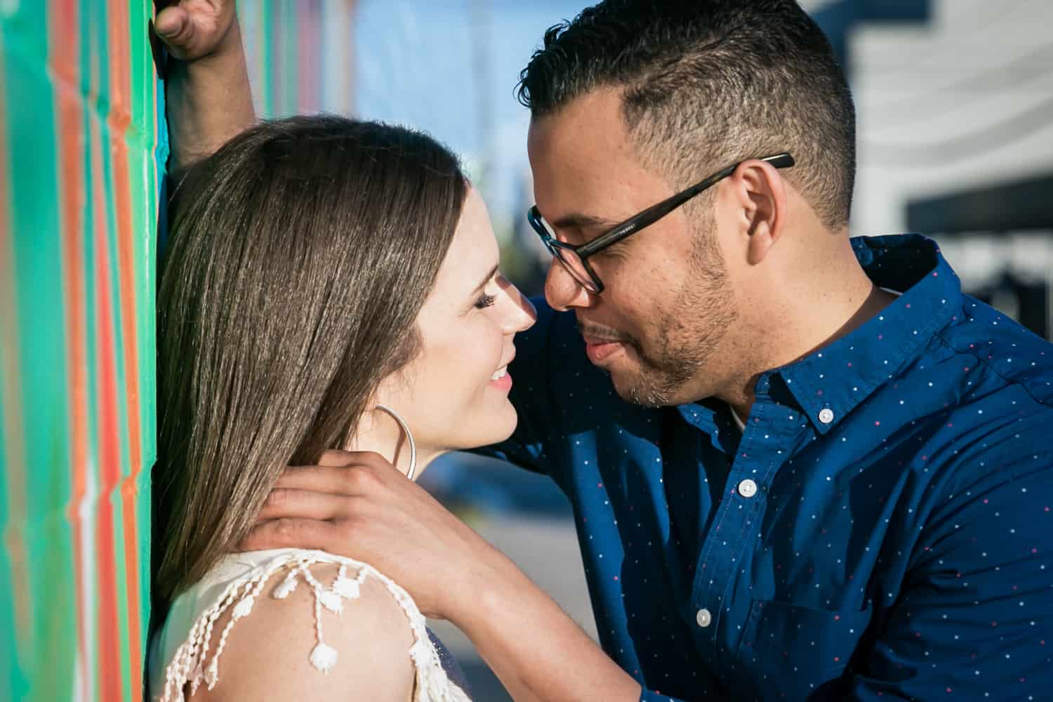 Man pulling woman close during an Astoria Park engagement shoot