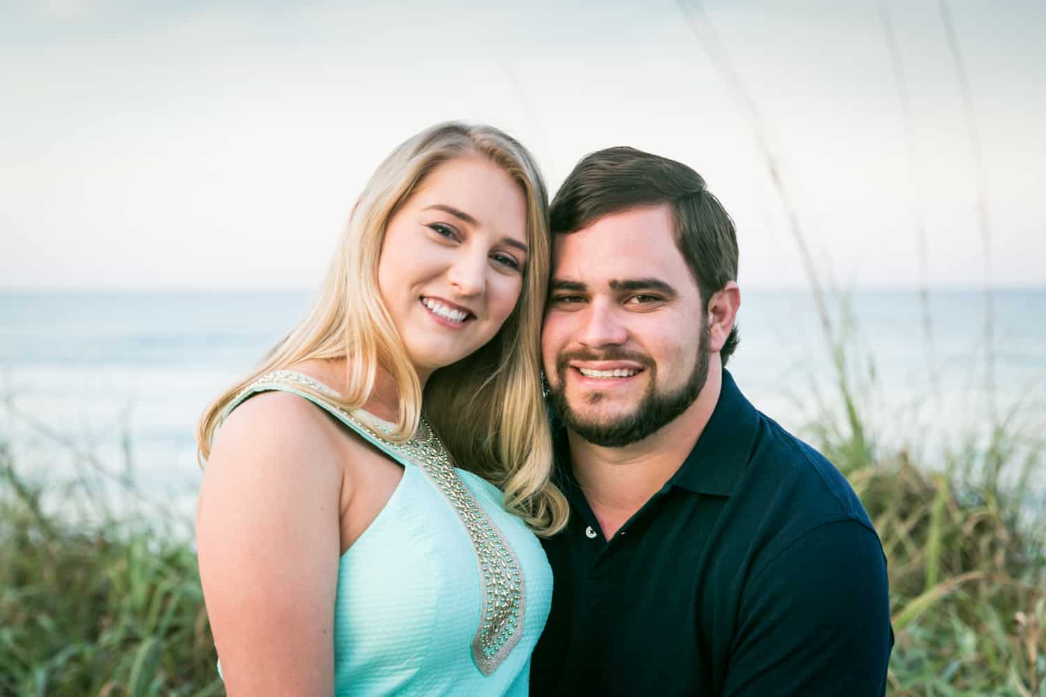 Couple in front of ocean during a Coral Cove Park engagement shoot