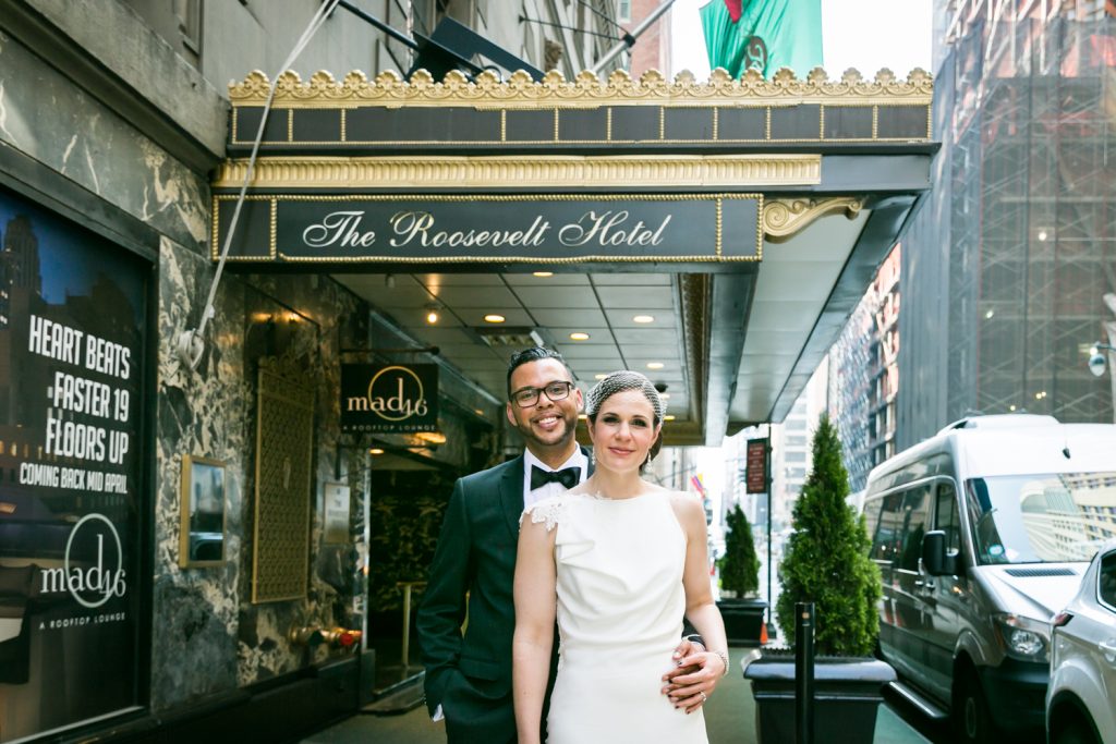 Bride and groom outside hotel entrance in Roosevelt Hotel wedding photo