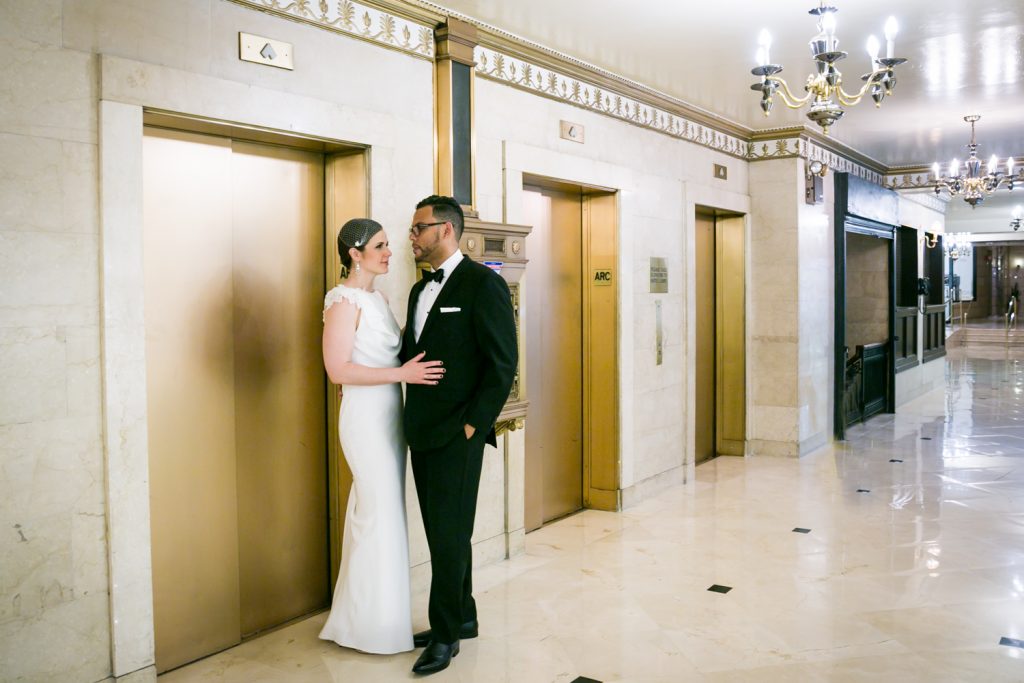 Bride and groom looking at each other in front of elevator in Roosevelt Hotel wedding photo