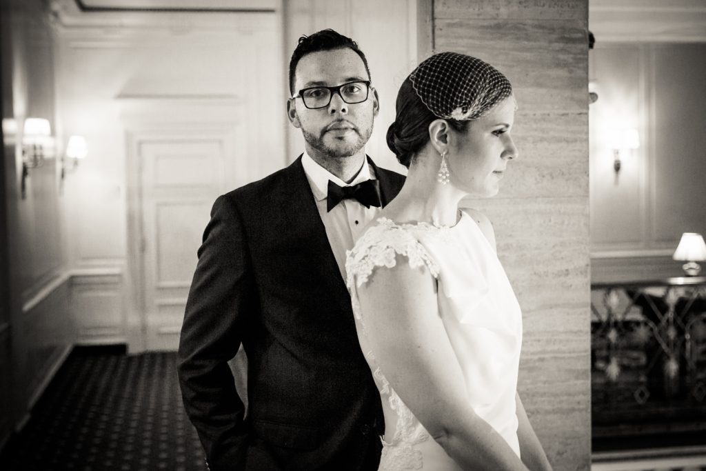Black and white portrait of bride and groom in hallway in Roosevelt Hotel wedding photo