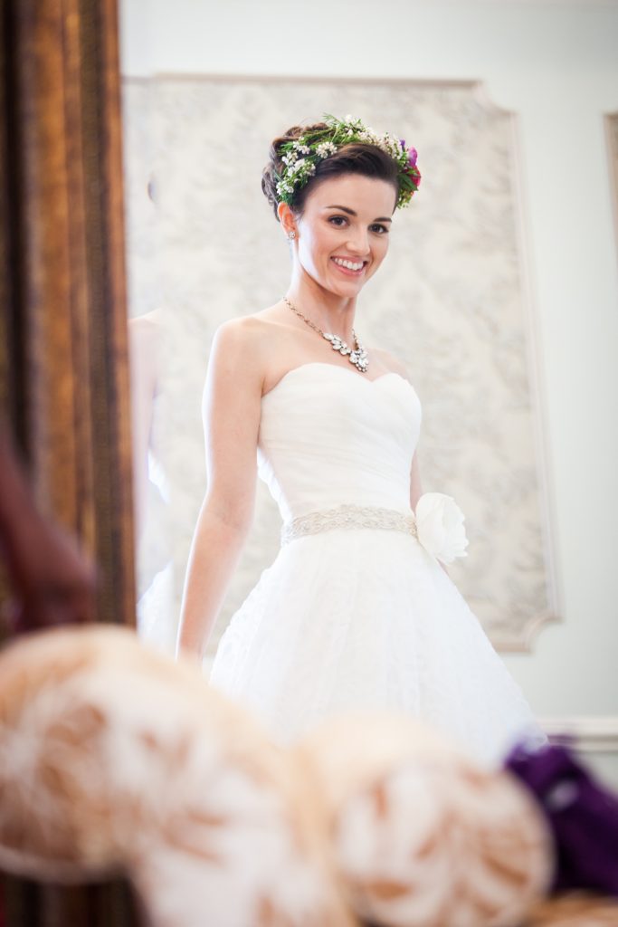 Bride smiling at herself in the mirror at a Snug Harbor wedding
