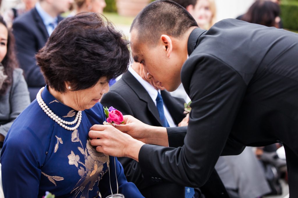Groom pinning flower to his mother at a Snug Harbor wedding