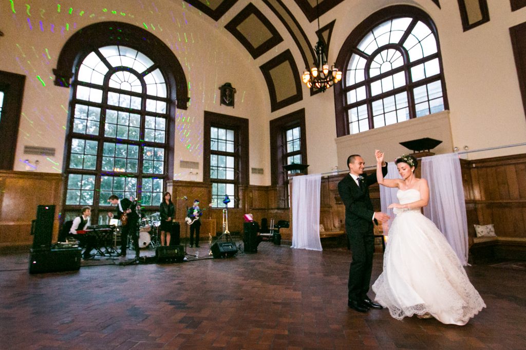 Bride and groom dancing in front of live band in Great Hall Ballroom