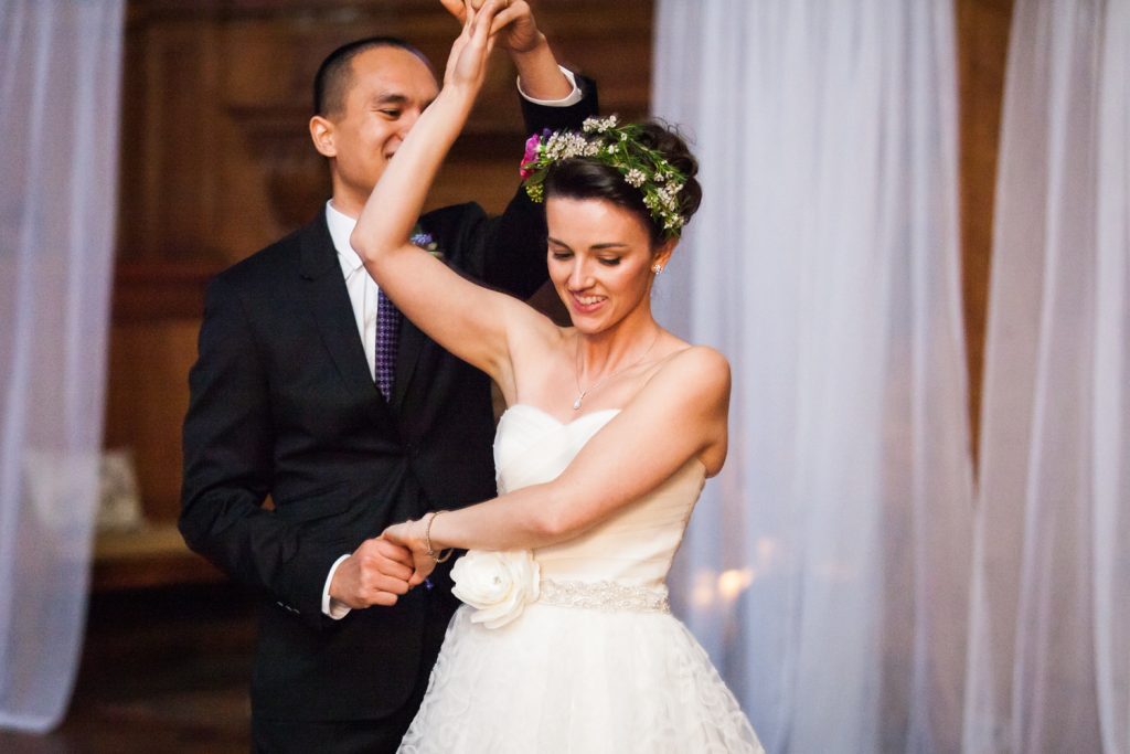 Groom twirling bride for article on how to get perfect first dance photos