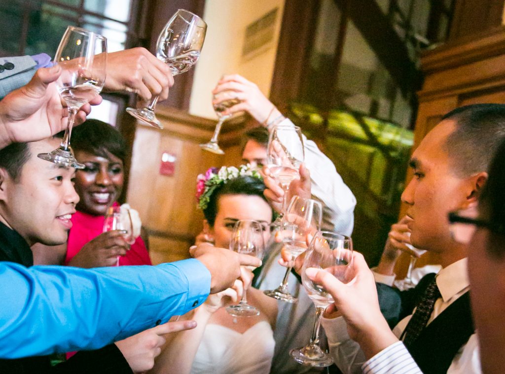 Guests cheering with glasses at a Snug Harbor wedding