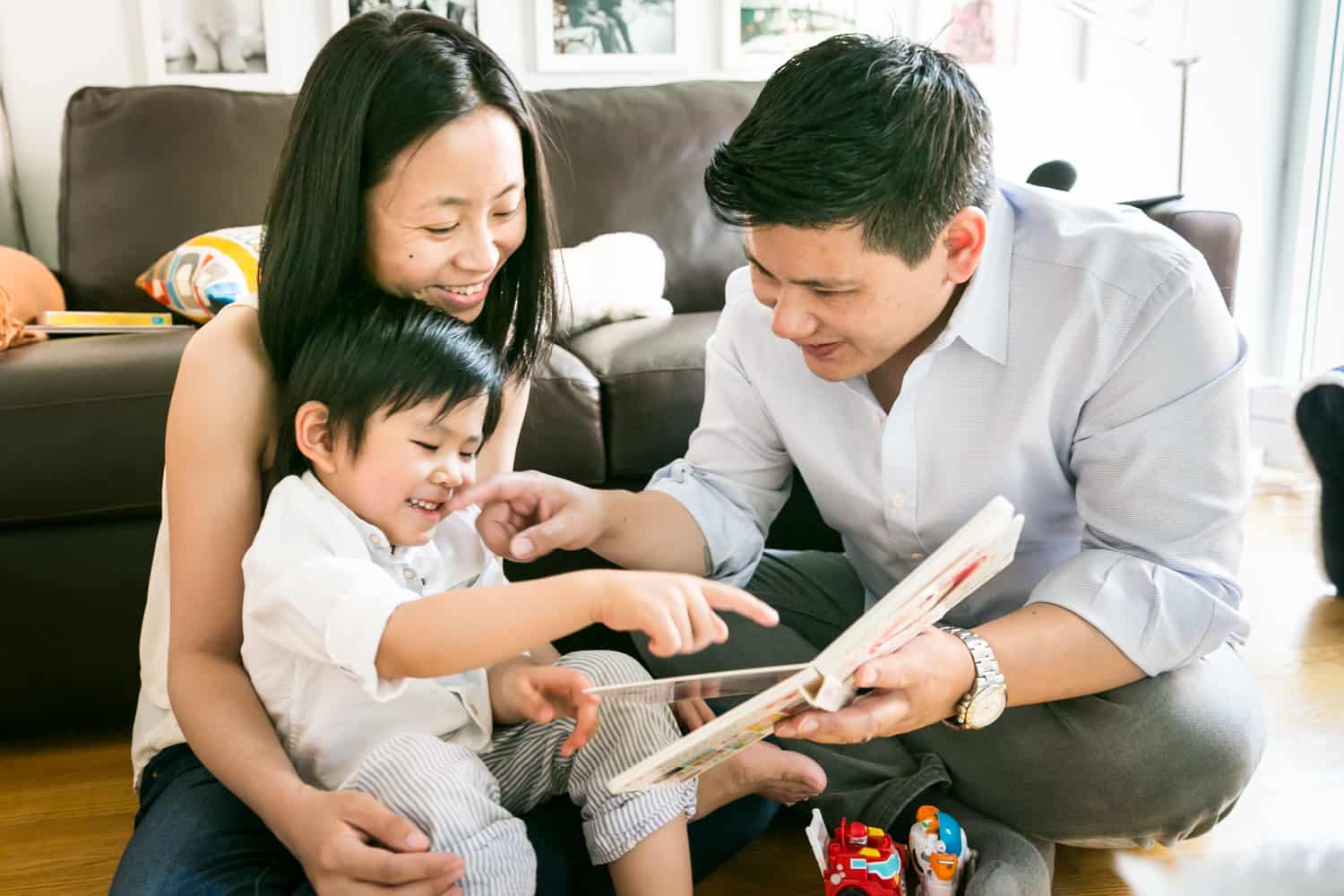 Chelsea family portrait of parents reading to little boy