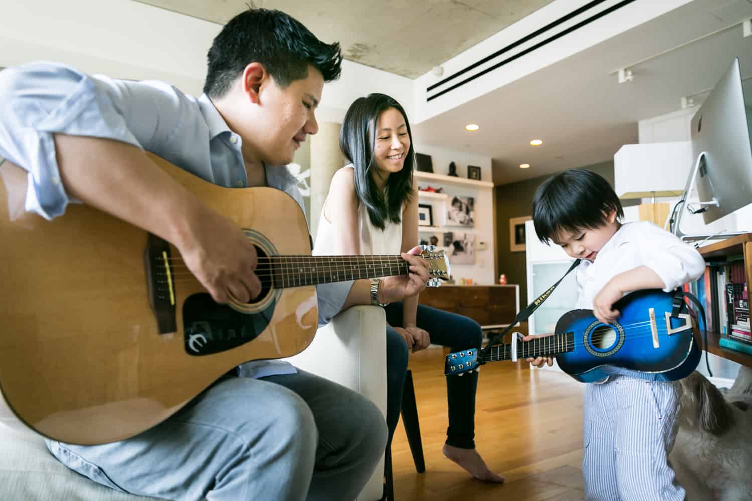 Chelsea family portrait of family playing guitar together