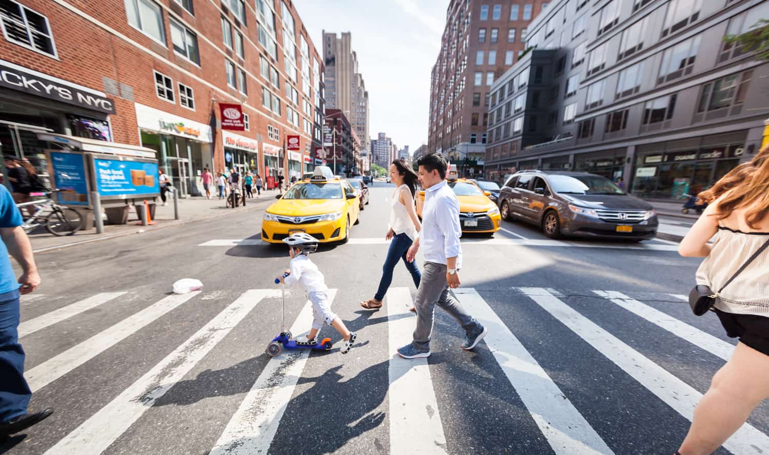 Chelsea family portrait of parents and little boy in Manhattan crosswalk