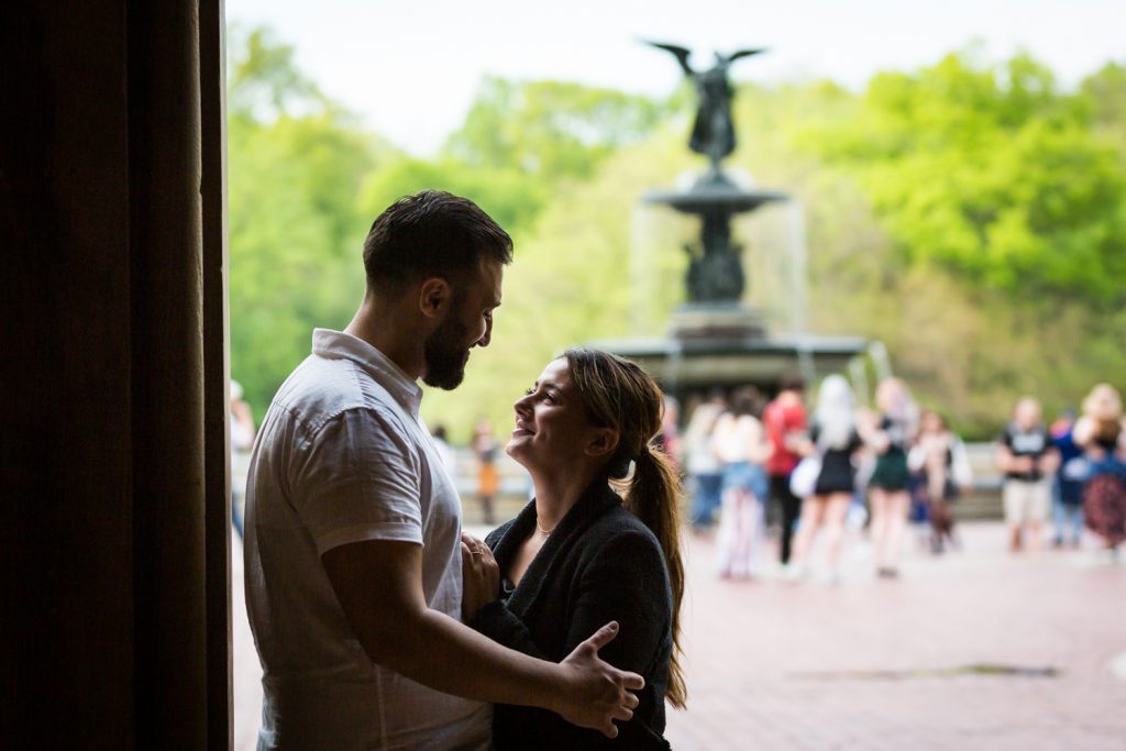 Couple looking at each other with Bethesda Fountain in the background