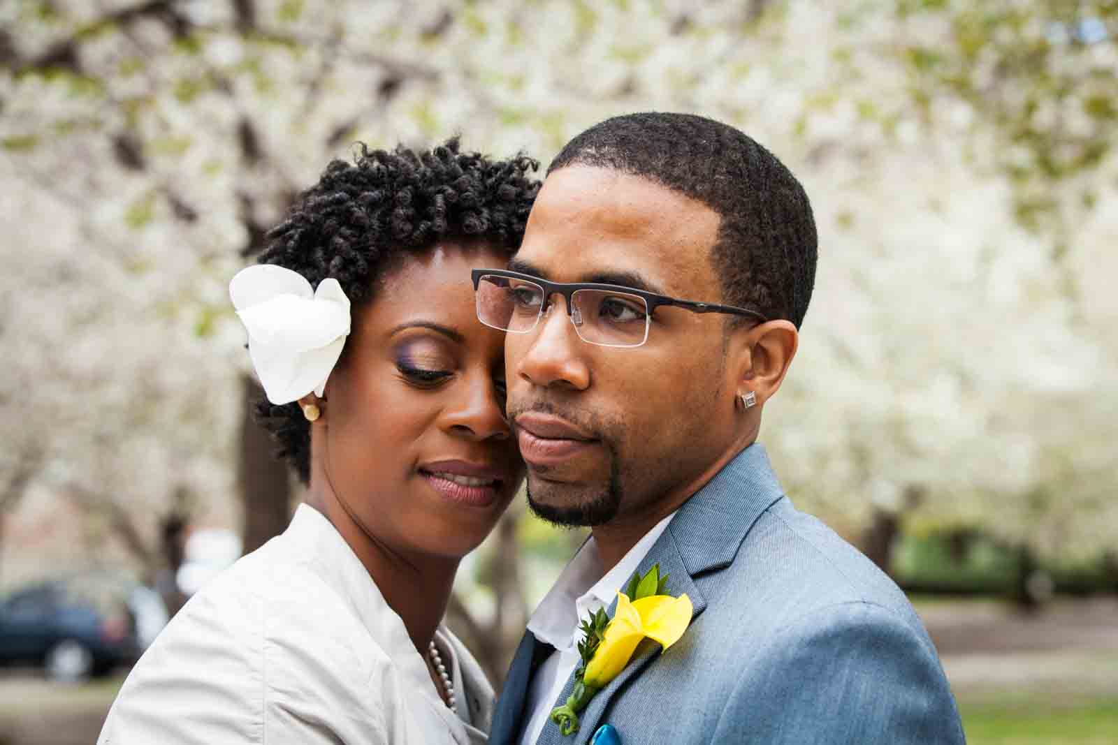 Portrait of bride and groom with cherry blossoms after first look