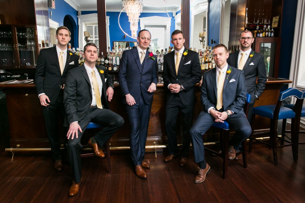 Portrait of groomsmen in the India House bar for an article on NYC rainy day photo tips