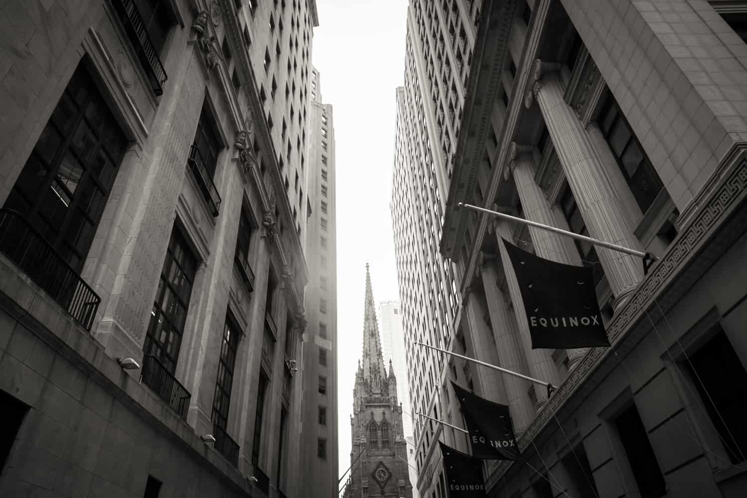 Black and white photo of Trinity Church through alleyway