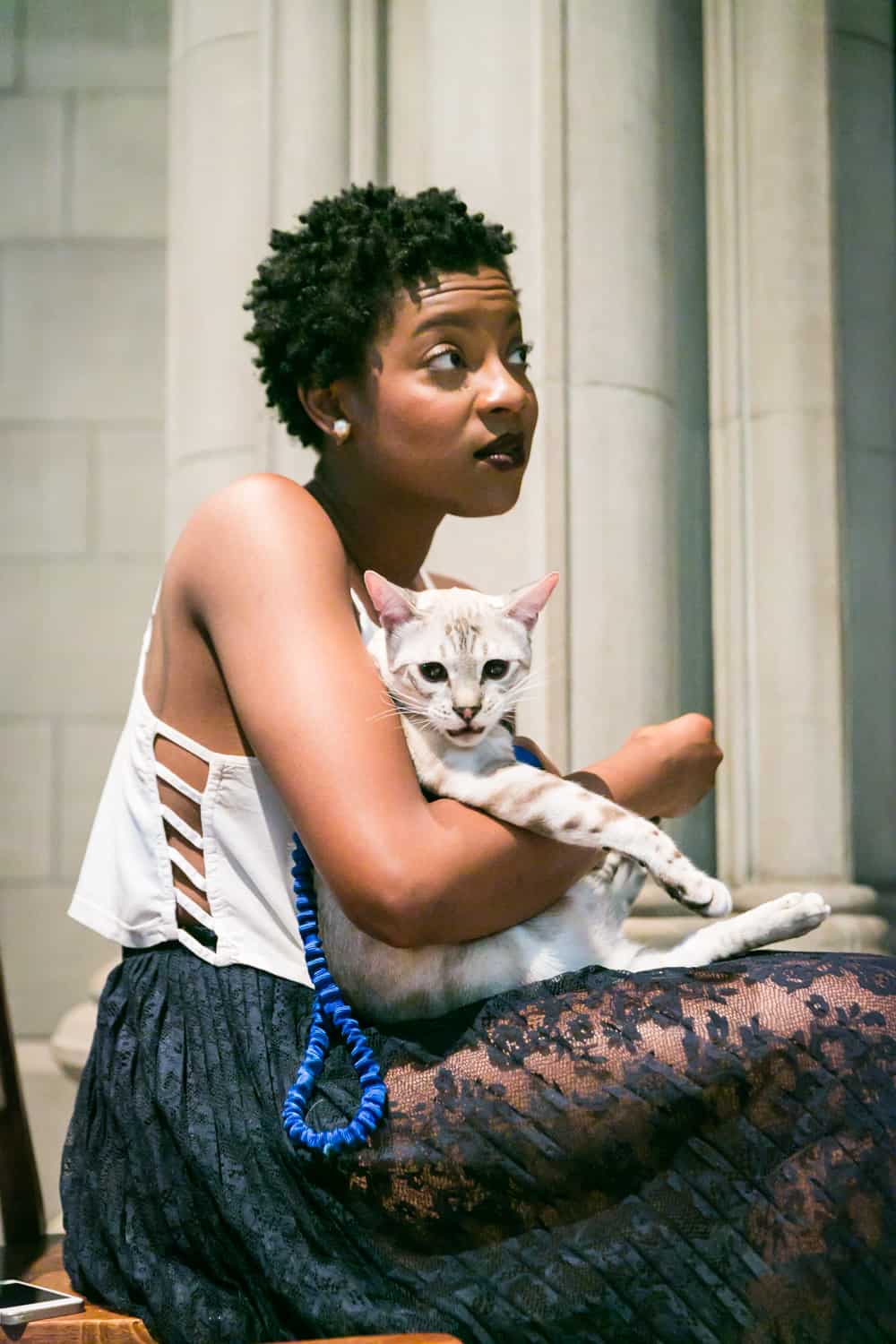 Maid of honor holding cat for an article on tips for including your pet in your wedding