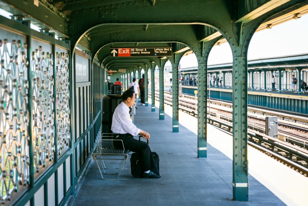 Man sitting on bench in subway platform