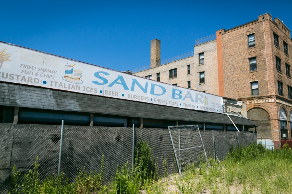 Sand Bar restaurant sign and fence in Far Rockaway