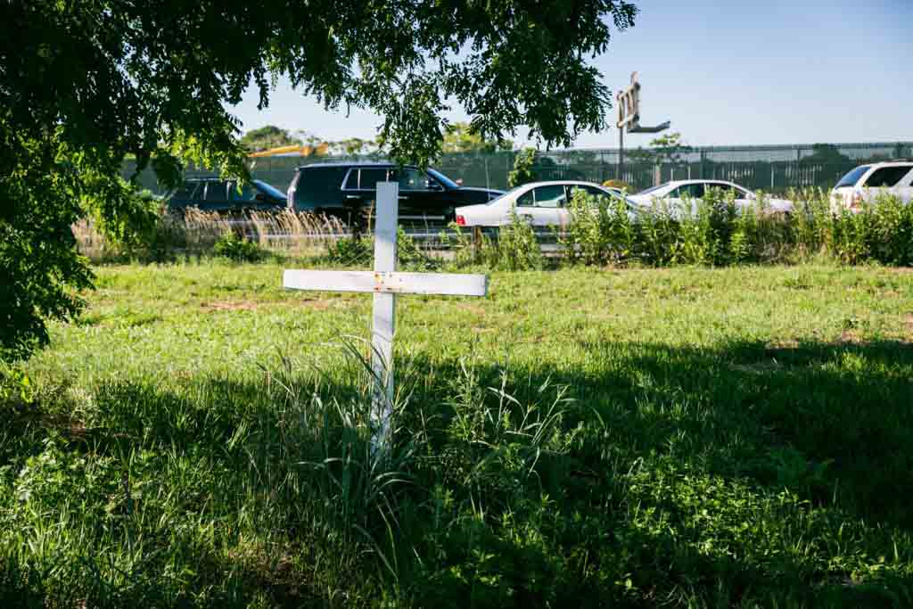 Dead Horse Bay photos of white cross in grass