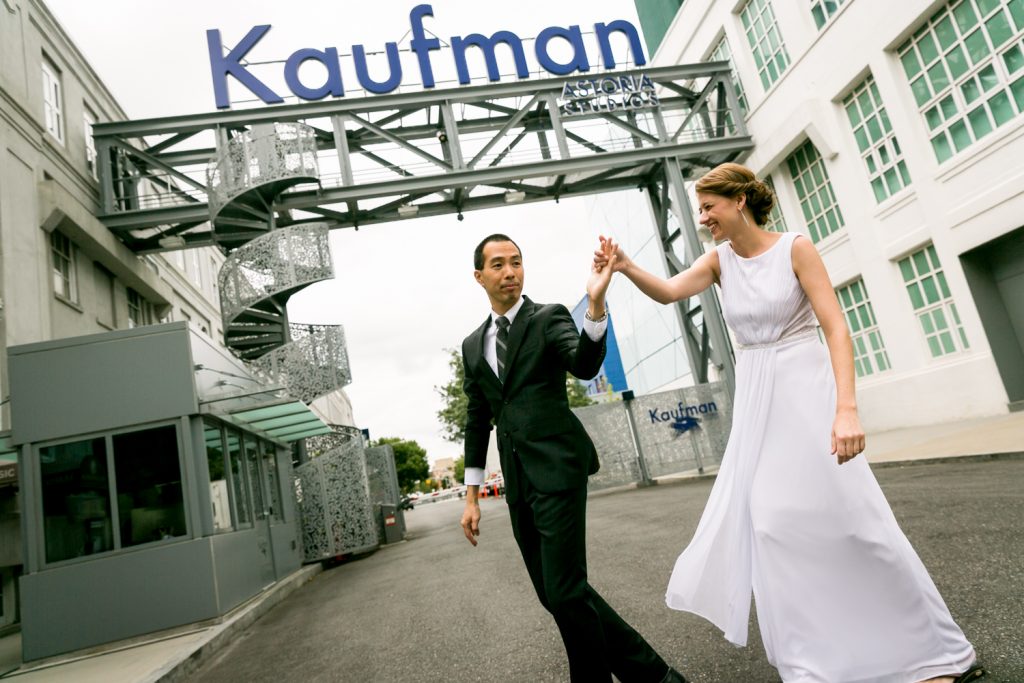 Bride and groom dancing underneath Kaufman Astoria Studios sign in Queens