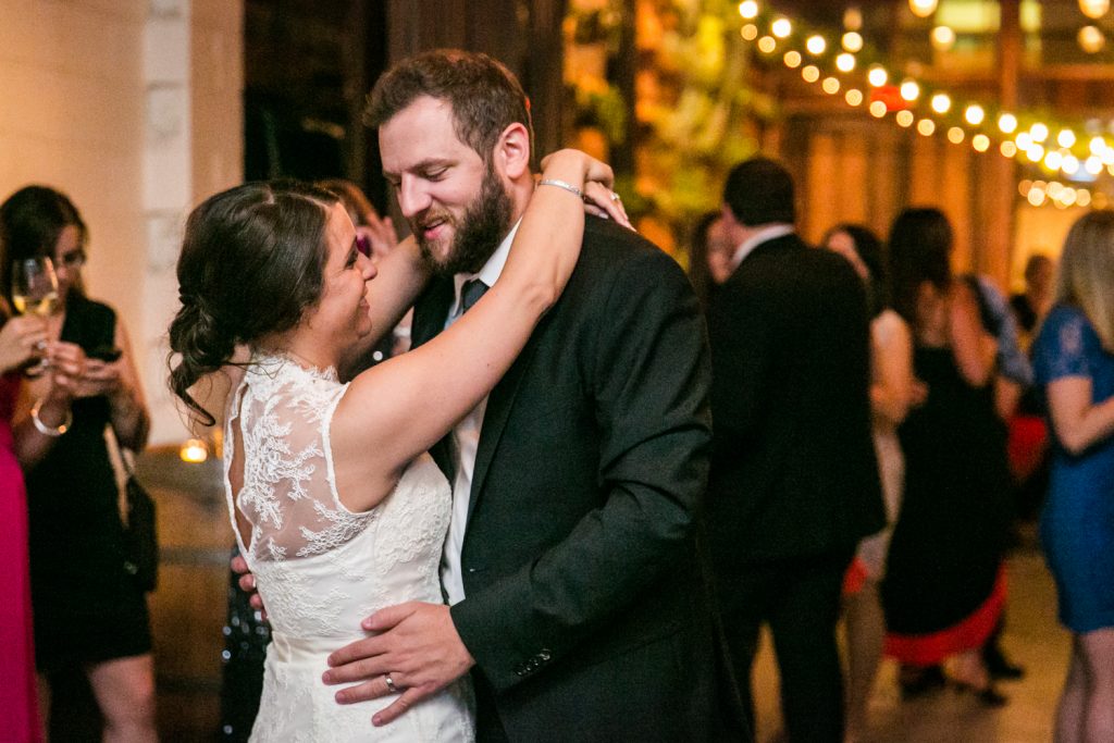 Bride and groom dancing in corner for article on how to get the perfect first dance photos
