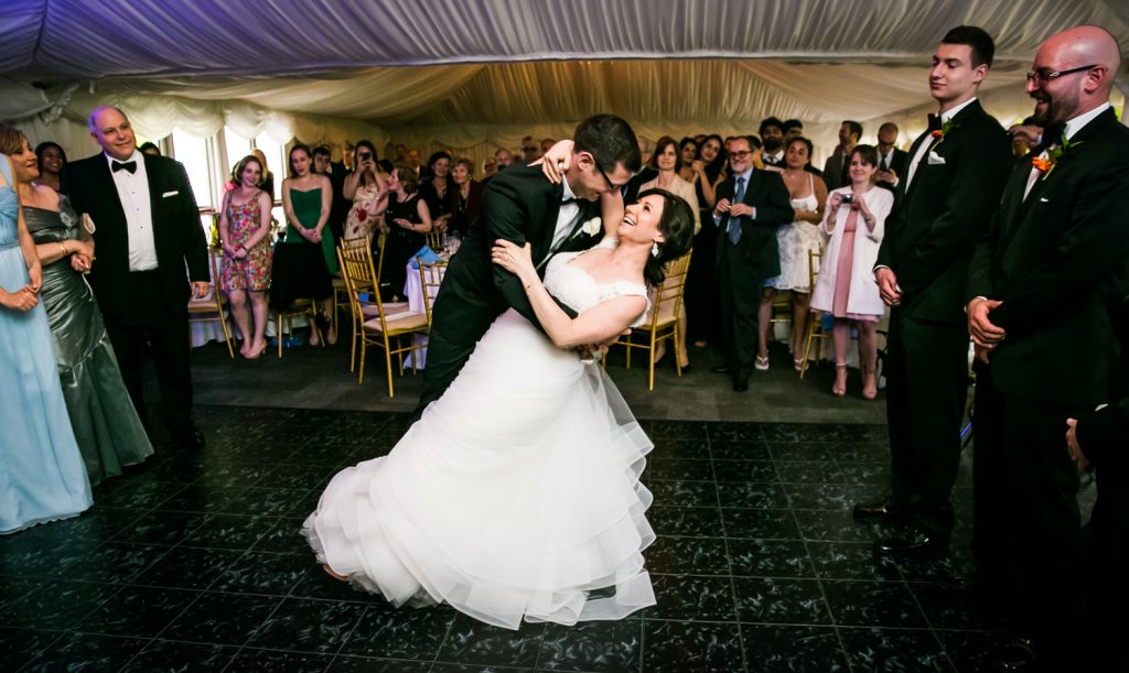 Groom dipping bride during first dance for article on how to get the perfect first dance photos