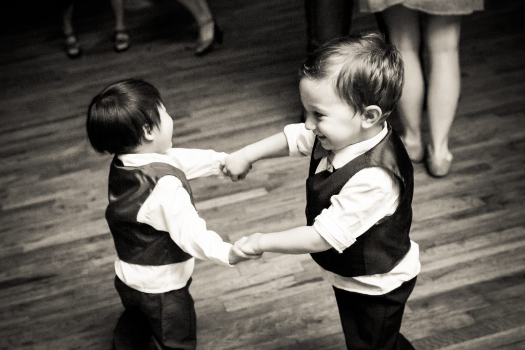 Black and white photo of two little boys dancing together