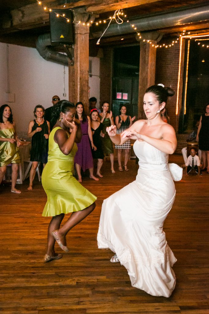 Bride and guest dancing at a DUMBO Loft wedding