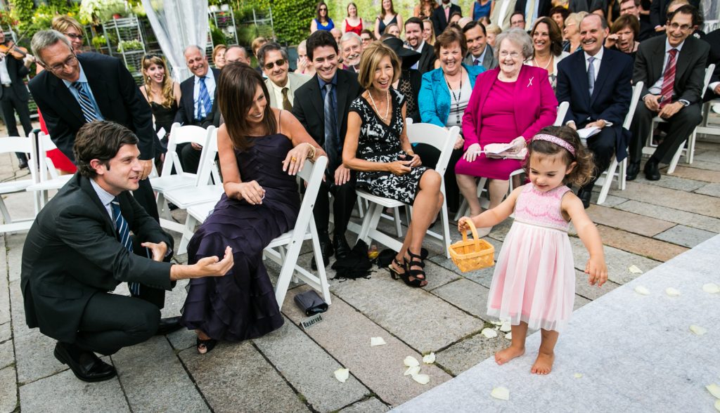 Little flower girl walking down aisle for an article on how to become a wedding officiant in NYC