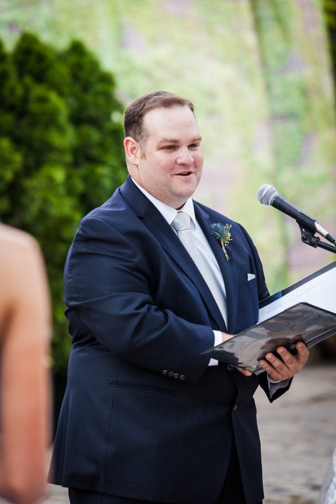 Man wearing suit and holding folder as wedding officiant for an article on how to become a wedding officiant in NYC