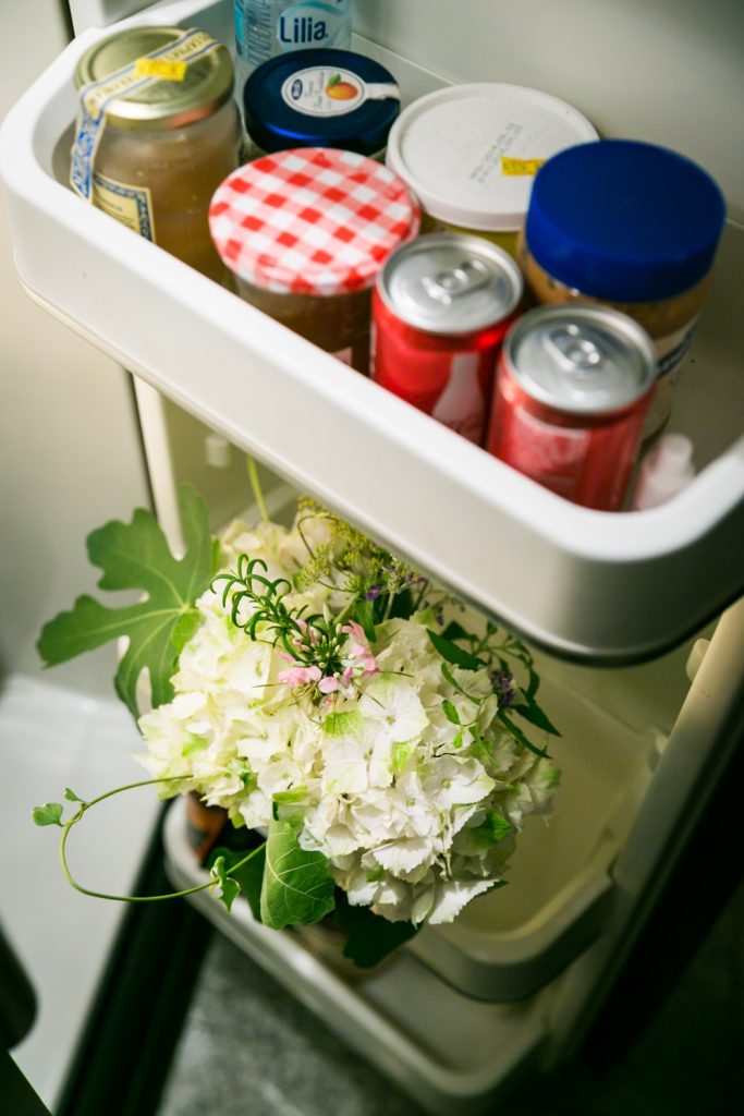 White bouquet of flowers in the door of a refrigerator