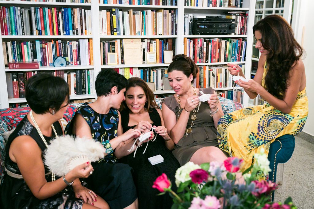 Female guests opening gifts at a NYC rehearsal dinner
