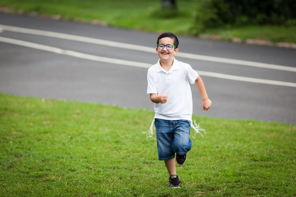 Prospect Park family photos of little boy wearing tzitzit and running