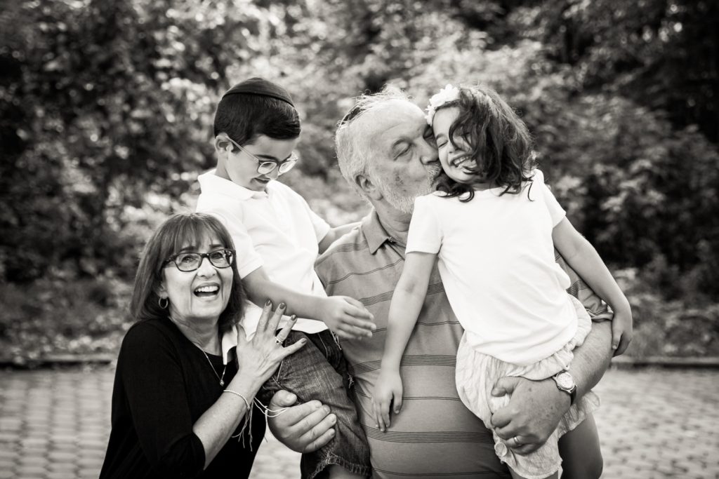 Black and white Prospect Park family photos of grandparents holding two grandkids