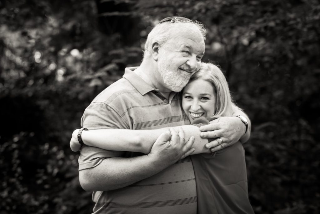 Black and white photo of father hugging daughter