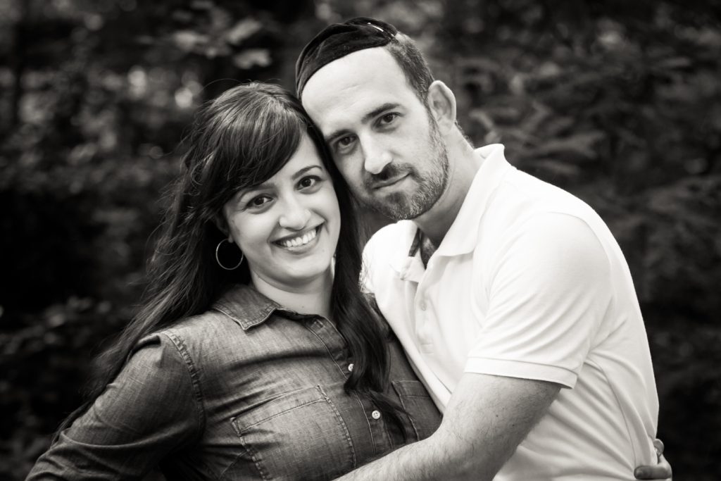 Black and white photo of man hugging his wife in Prospect Park