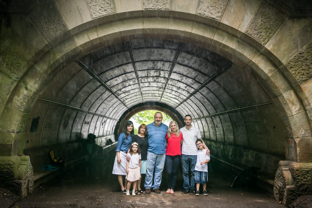 Family of seven posed under arch in Prospect Park