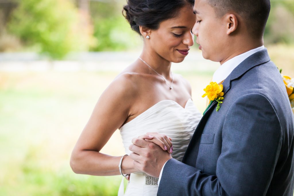 Bride and groom dancing in field for an article on when should my wedding photographer arrive