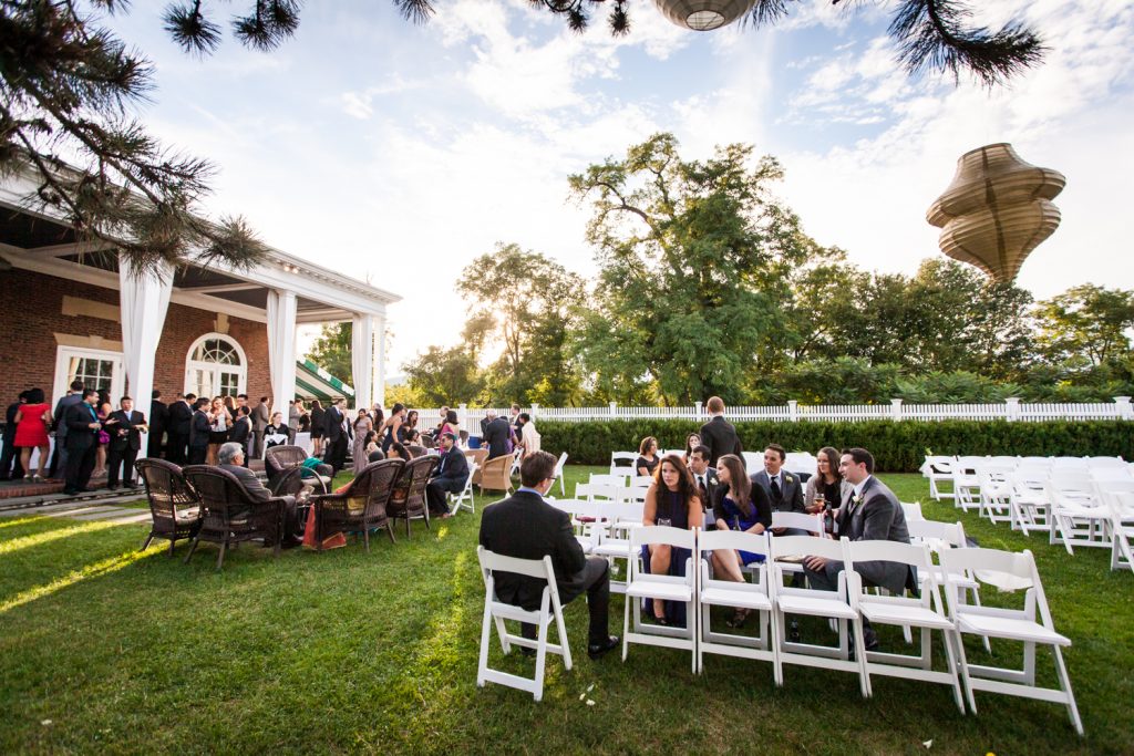 Guests seated outside for cocktail hour at Highlands Country Club wedding ceremony