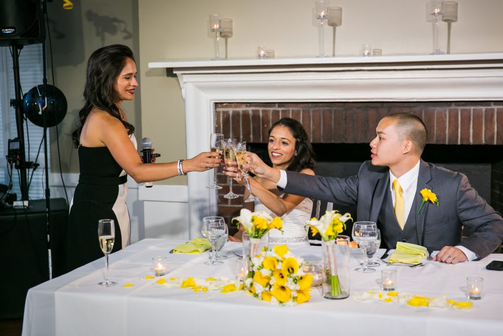 Bridesmaid toasting champagne glass with bride and groom at Highlands Country Club wedding ceremony