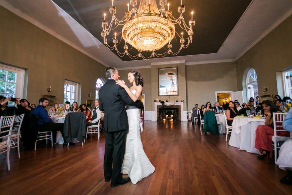 Bride dancing with father underneath chandelier at Highlands Country Club wedding ceremony