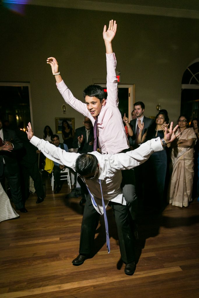 Two guests dancing wildly with arms raised
