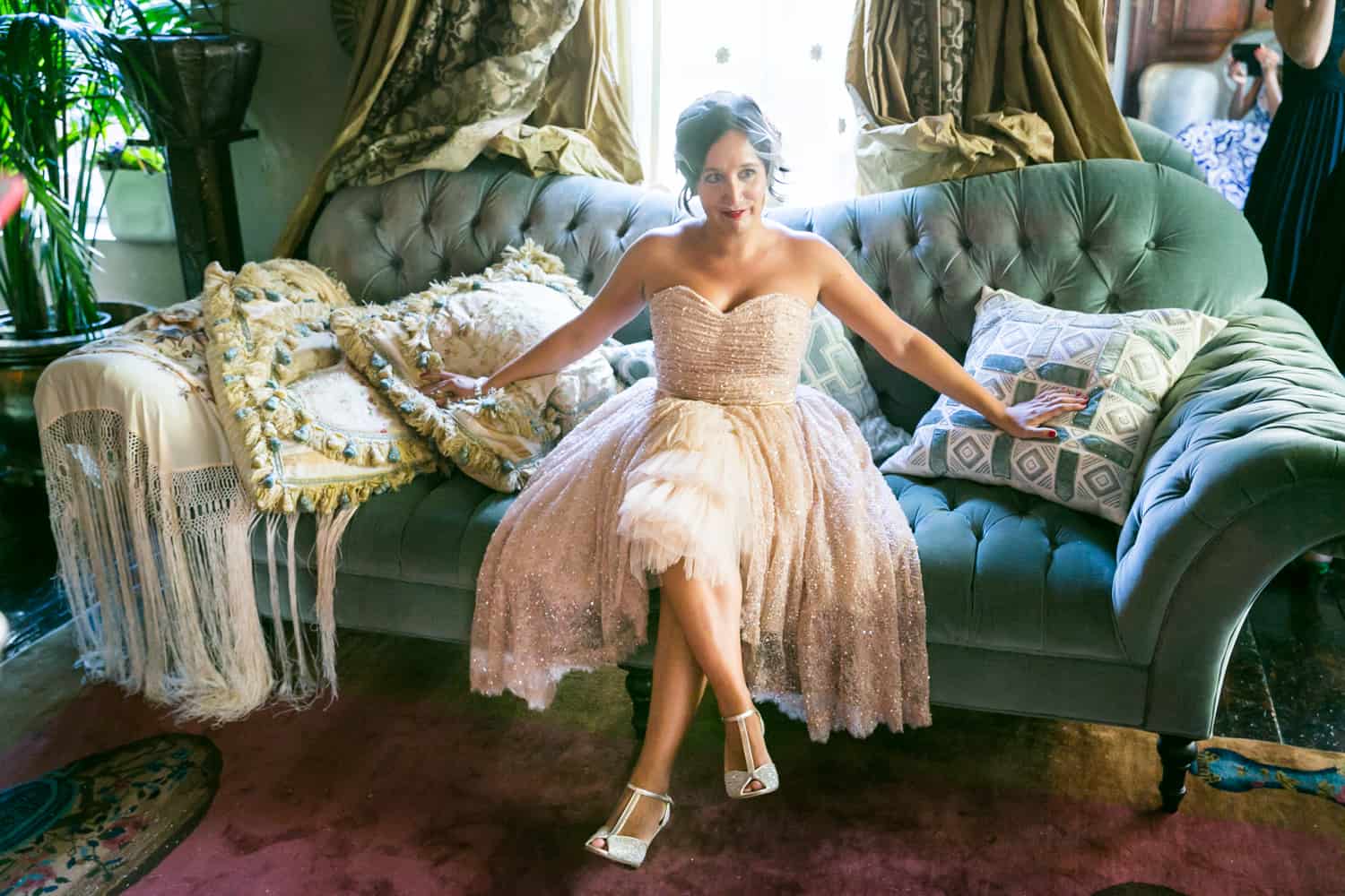 Bride wearing 1920s-style dress on couch at a 632 on Hudson wedding