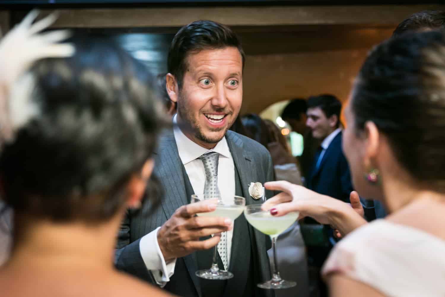 Groom toasting cocktails with guest at a 632 on Hudson wedding