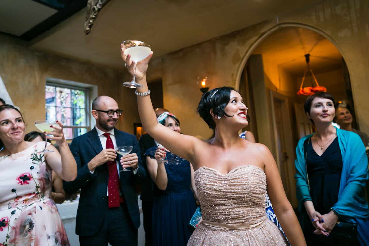 Bride lifting up cocktail at a 632 on Hudson wedding
