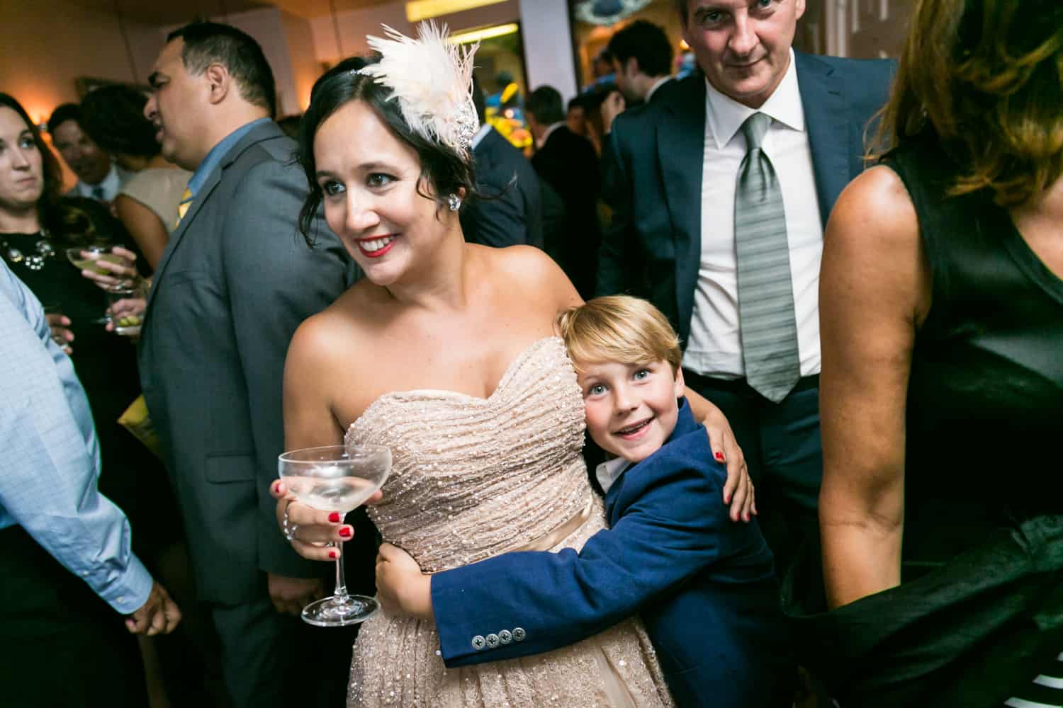 Little blond boy hugging bride at a 632 on Hudson wedding