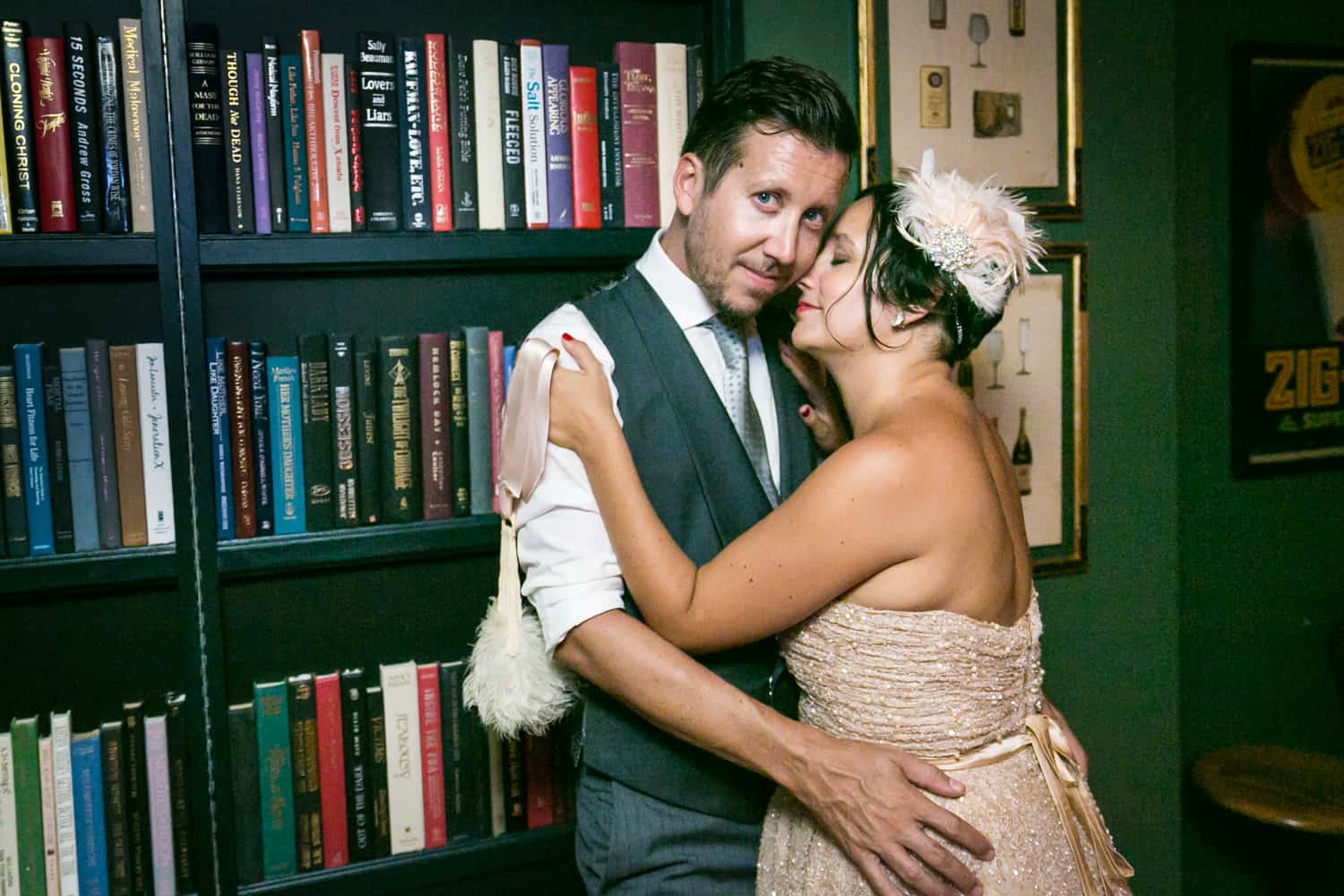 Bride and groom hugging in front of bookcase at a 632 on Hudson wedding