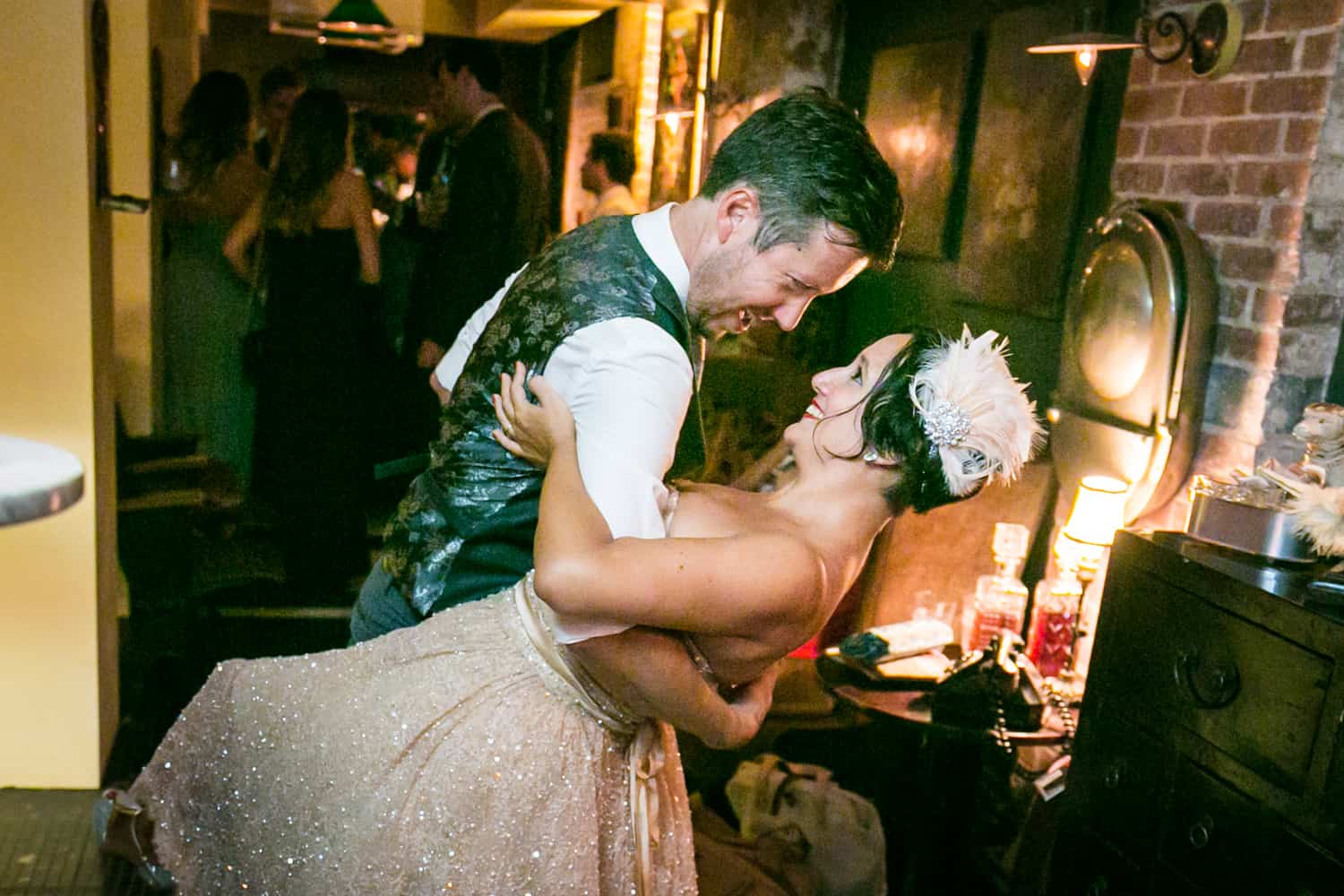 Groom dipping bride in brick speakeasy at a 632 on Hudson wedding