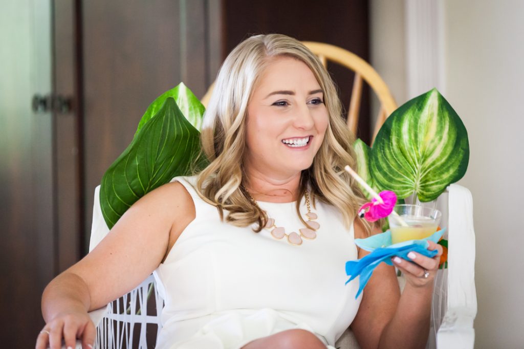 Bride-to-be holding a drink and smiling at a Florida bridal shower