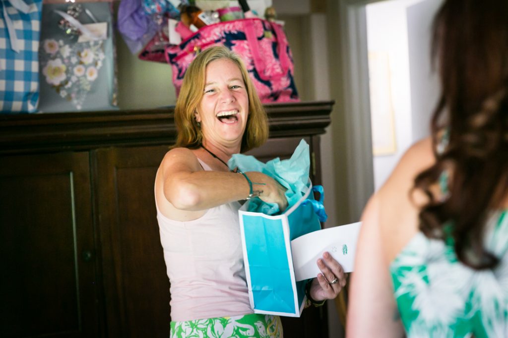 Guest opening gift in blue bag during Florida bridal shower